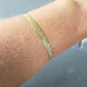 Women's reversible gold tone bracelet.